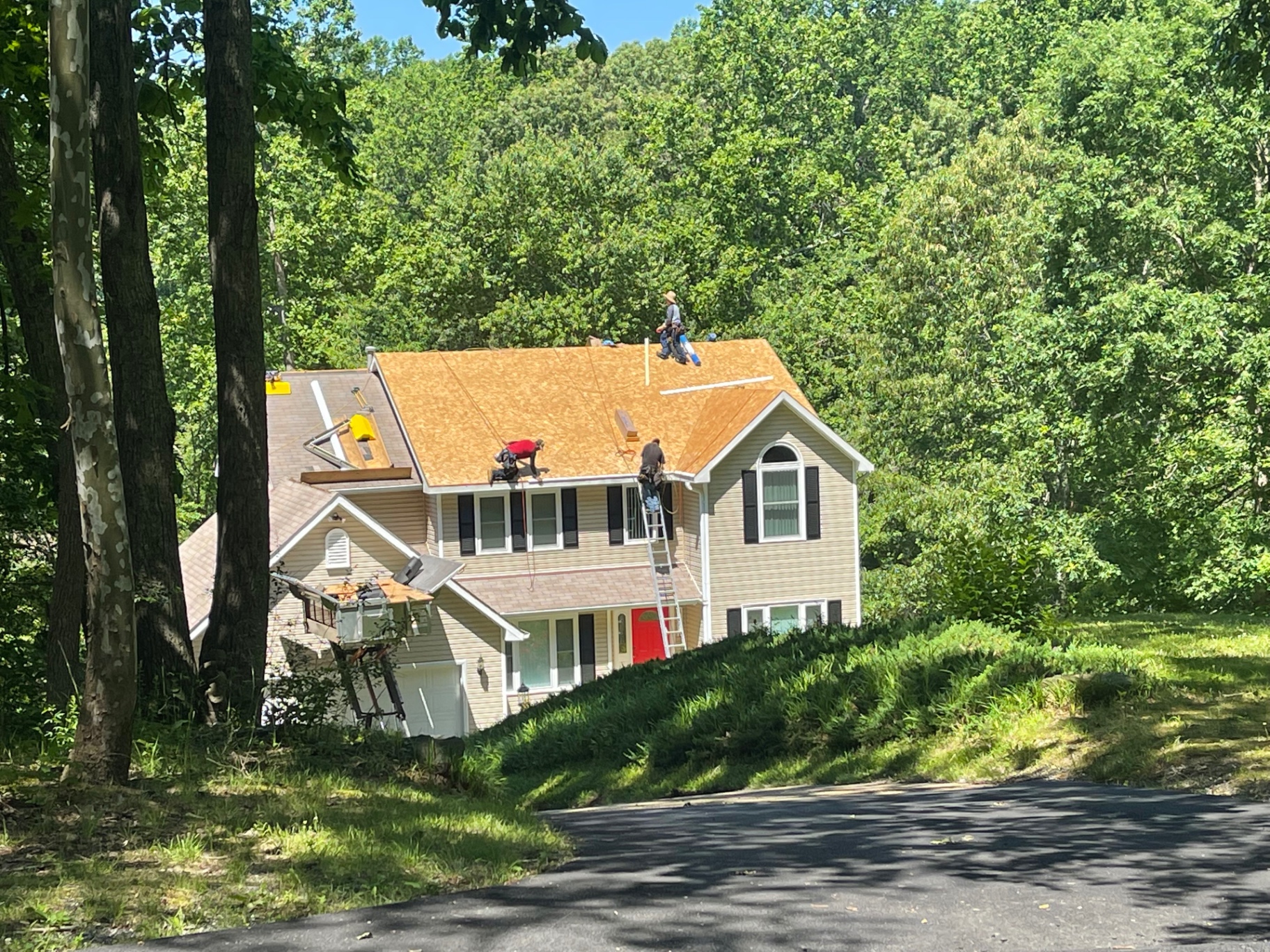 Magic RoofWorks crew installing new decking on a full replacement